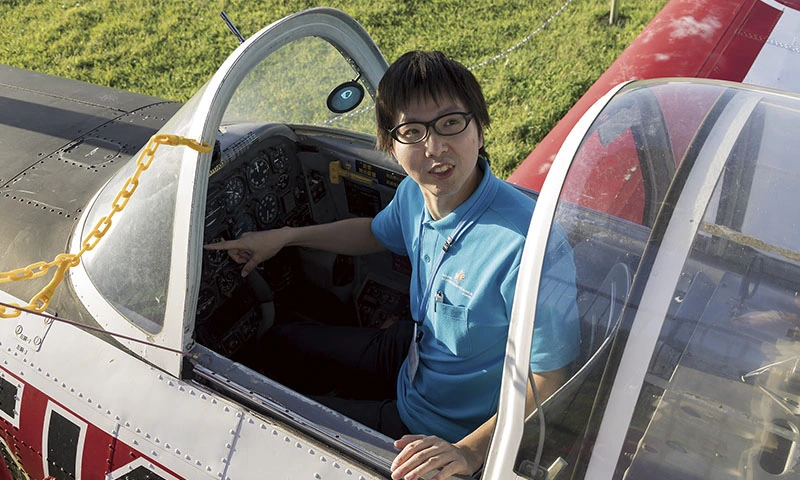 カートピア 三沢市大空ひろばにある富士重工業製のT-3初等練習機のコクピットに座る月舘晋一さん | SUBARU
