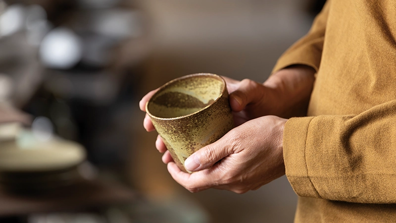 カートピア 回廊ギャラリー門で、器に手を取る自動車ジャーナリスト渡辺慎太郎さん | SUBARU